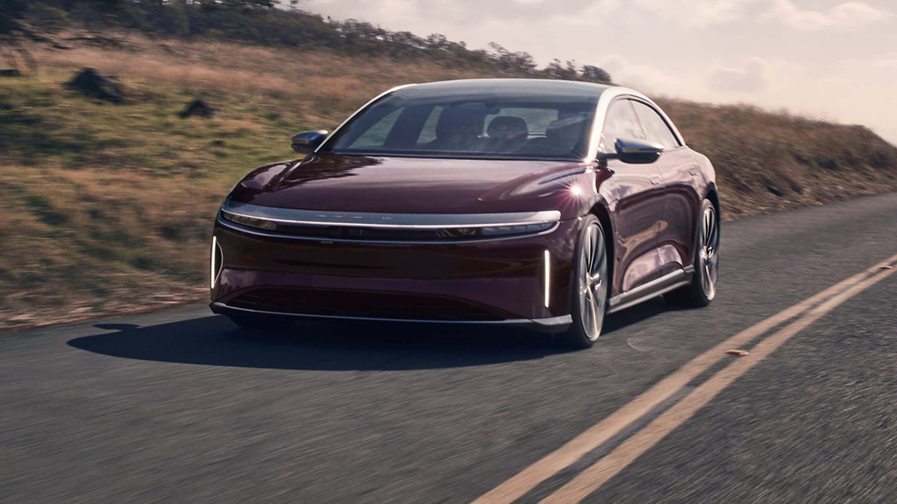 51f423db/2024 lucid air grand touring ev press gtlaunch ext gt zenithred lifestyle1 jpg